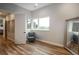 Bright bedroom with wood floors, chair, and a large window at 11229 Running Kit Pl, Franktown, CO 80116