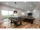 Spacious game room with a pool table, shuffleboard, and entertainment area at 11229 Running Kit Pl, Franktown, CO 80116