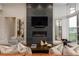 Beautiful living room featuring a tiled fireplace, modern furniture, and bright windows at 11229 Running Kit Pl, Franktown, CO 80116