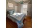 Bright bedroom features hardwood floors, window, and ensuite bathroom at 3890 N Wolff St, Denver, CO 80212