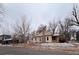 Exterior of home with a brick chimney and winter landscaping at 3890 N Wolff St, Denver, CO 80212