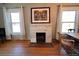 The fireplace is the focal point of this living room with two windows and an eating area at 3890 N Wolff St, Denver, CO 80212