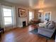 Cozy living room featuring hardwood floors, a fireplace, and ample natural light at 3890 N Wolff St, Denver, CO 80212