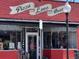 The outside of a Pizza Love Beer restaurant, with a red brick wall and a painted sign at 3890 N Wolff St, Denver, CO 80212