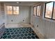 Sunroom with beadboard walls, multiple windows, and a decorative rug at 3890 N Wolff St, Denver, CO 80212