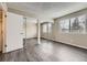 Second bedroom with mirrored closet doors and grey wood-look flooring at 1312 S Cathay Ct # 202, Aurora, CO 80017