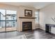 Cozy fireplace with a modern mantel and glass doors at 1312 S Cathay Ct # 202, Aurora, CO 80017