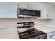 Stainless steel appliances and white cabinets in this kitchen at 1312 S Cathay Ct # 202, Aurora, CO 80017