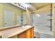 Well-lit bathroom featuring a shower over tub and vanity with ample counter space, perfect for morning routines at 17205 Waterhouse Cir # C, Parker, CO 80134