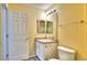 Bathroom featuring a toilet, single sink vanity, mirror and a medicine cabinet at 17205 Waterhouse Cir # C, Parker, CO 80134