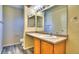 Vanity in bathroom featuring a mirror and wood-look flooring at 17205 Waterhouse Cir # C, Parker, CO 80134