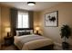 Neutral-toned bedroom with large window, plush bedding, and stylish decor, perfect for relaxation and rest at 17205 Waterhouse Cir # C, Parker, CO 80134