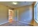 A carpeted bedroom with a window, closet, overhead lighting and a doorway to the hall at 17205 Waterhouse Cir # C, Parker, CO 80134