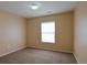 A carpeted bedroom with a window and overhead lighting at 17205 Waterhouse Cir # C, Parker, CO 80134
