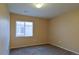 A carpeted bedroom with a window and overhead lighting at 17205 Waterhouse Cir # C, Parker, CO 80134