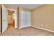 Carpeted bedroom with closet and doorway at 17205 Waterhouse Cir # C, Parker, CO 80134