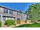 Townhome exterior with well-maintained lawn and lush greenery, offering a peaceful suburban setting at 17205 Waterhouse Cir # C, Parker, CO 80134