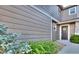 Stylish condo entrance with neutral siding, well maintained landscaping, and decorative door wreath at 17205 Waterhouse Cir # C, Parker, CO 80134
