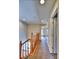 Upstairs hallway with carpet, recessed lights, and wood handrail at 17205 Waterhouse Cir # C, Parker, CO 80134