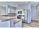 Bright kitchen with stainless steel appliances, white cabinets and breakfast bar at 17205 Waterhouse Cir # C, Parker, CO 80134