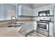 Well-lit kitchen features stainless steel appliances, double sink, and light countertops at 17205 Waterhouse Cir # C, Parker, CO 80134