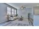 Bright living room with large windows, stylish decor, and gray vinyl flooring at 17205 Waterhouse Cir # C, Parker, CO 80134