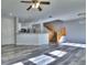 Open-concept living area with wood stairs, vinyl flooring, and kitchen view at 17205 Waterhouse Cir # C, Parker, CO 80134