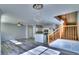 Open-concept living area with chandelier, vinyl flooring, kitchen view, and wood stairs at 17205 Waterhouse Cir # C, Parker, CO 80134