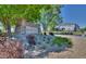 Community entrance sign with stone landscaping and 'Prairie Meadows' lettering at 17205 Waterhouse Cir # C, Parker, CO 80134