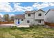 Spacious backyard featuring a well-maintained lawn, patio, and a charming blue door at 13906 Jackson St, Thornton, CO 80602