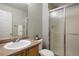 Clean bathroom featuring a single sink vanity and enclosed shower with sliding glass doors at 13906 Jackson St, Thornton, CO 80602