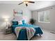 Cozy bedroom featuring stylish decor, a plush bed, and a window providing natural light at 13906 Jackson St, Thornton, CO 80602
