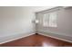 Neutral bedroom with laminate floors, large window, and modern lamp at 13906 Jackson St, Thornton, CO 80602
