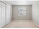 This bedroom offers natural light and ample closet space with neutral walls and carpeting throughout at 13906 Jackson St, Thornton, CO 80602