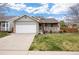 Charming single-Gathering home featuring stone accents, a well-manicured lawn, and a covered front porch at 13906 Jackson St, Thornton, CO 80602