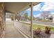 Inviting front porch with white railing, offering a view of the street and surrounding neighborhood at 13906 Jackson St, Thornton, CO 80602
