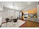 Inviting kitchen and dining area featuring hardwood floors and stainless steel appliances at 13906 Jackson St, Thornton, CO 80602