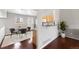 Dining space with hardwood floors, modern chairs, and seamless kitchen access at 13906 Jackson St, Thornton, CO 80602