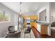 Well-lit kitchen and dining area featuring hardwood floors and stainless steel appliances at 13906 Jackson St, Thornton, CO 80602
