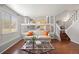 Open concept living room with a plush sofa, modern coffee table, and clear views to the kitchen at 13906 Jackson St, Thornton, CO 80602