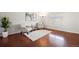 Bright living room with hardwood floors, a large window, and tasteful decor at 13906 Jackson St, Thornton, CO 80602
