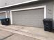 Image of a garage door with a gray facade and traditional paneled design at 1326 Sable Blvd, Aurora, CO 80011