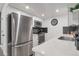 Contemporary kitchen with stainless steel appliances, white cabinets, and quartz countertops at 1326 Sable Blvd, Aurora, CO 80011