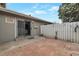 Back patio with sliding glass doors to the home and a fenced yard at 1326 Sable Blvd, Aurora, CO 80011
