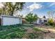 Expansive backyard with lush greenery, garden beds, and a patio, offering a serene outdoor living space at 2658 W 1St Ave, Denver, CO 80219