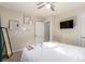 Inviting bedroom with a ceiling fan, flat screen TV, and floating shelves at 2658 W 1St Ave, Denver, CO 80219