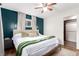 Bright bedroom features a ceiling fan, neutral color palette, and en-suite closet at 2658 W 1St Ave, Denver, CO 80219