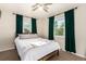 Relaxing bedroom features a ceiling fan, windows, and decorative emerald curtains at 2658 W 1St Ave, Denver, CO 80219