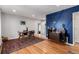 Dining room with hardwood floors, modern furniture, and a blue accent wall at 2658 W 1St Ave, Denver, CO 80219