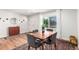 Sunlit dining area featuring hardwood floors, seating for four, and modern decor at 2658 W 1St Ave, Denver, CO 80219